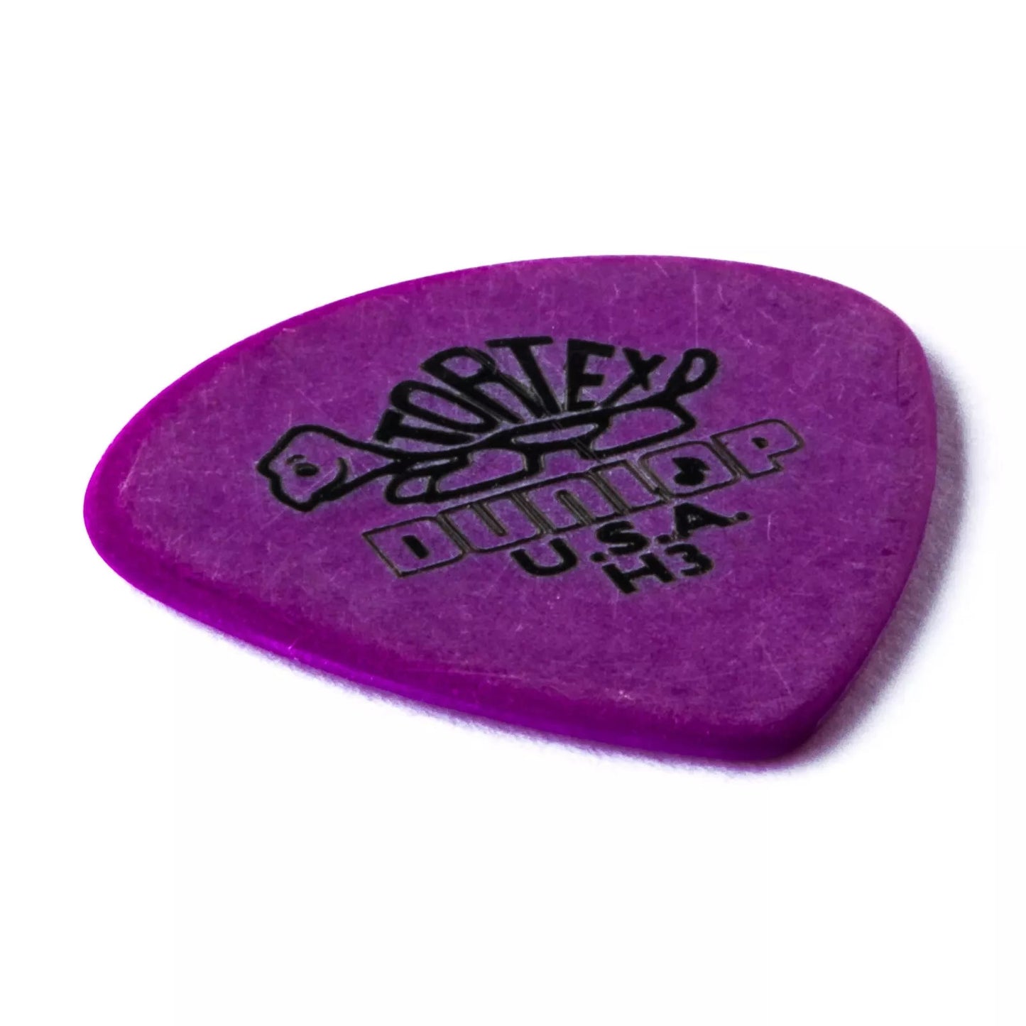 Packaging of Dunlop Tortex Jazz III guitar picks with six pieces per pack, 1.14mm thickness, in a purple color with the Dunlop logo and product information.