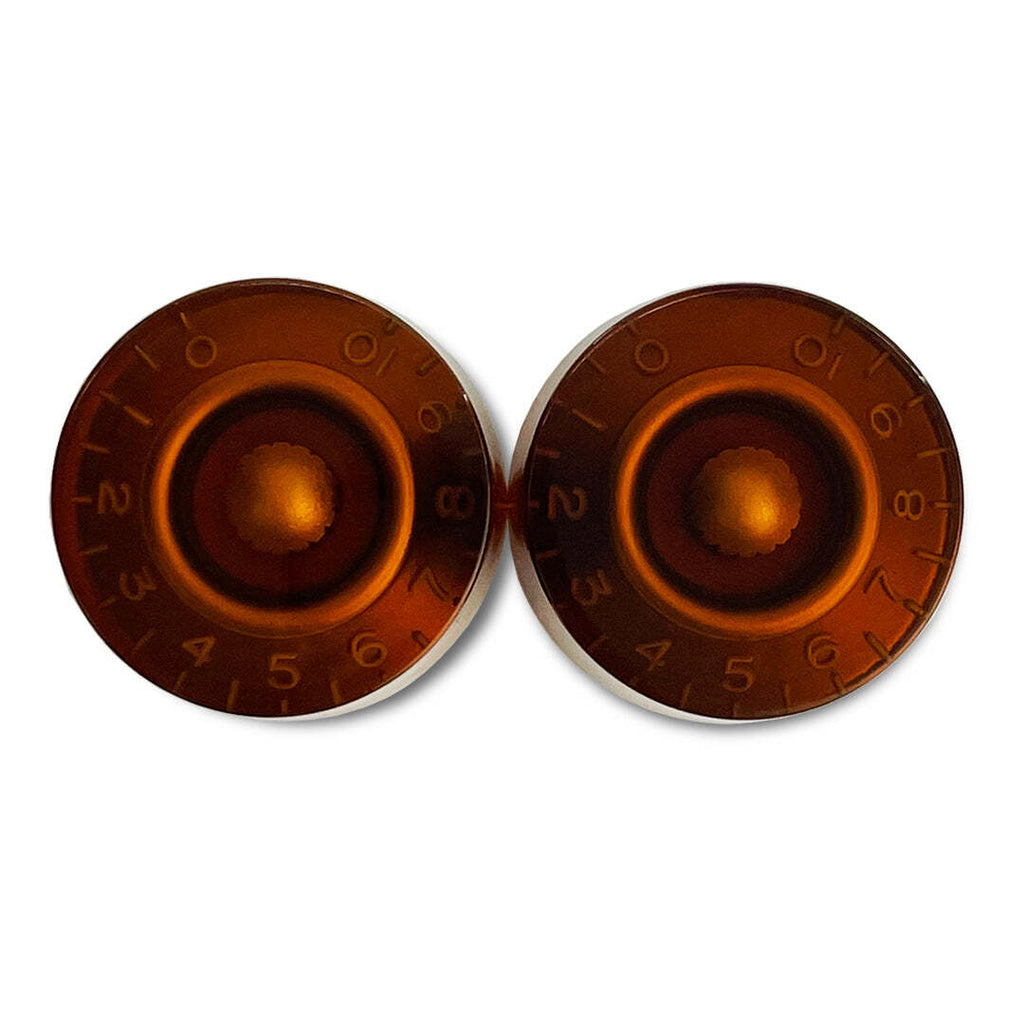 Two round metallic objects with a central hole and numerical markings on a white background