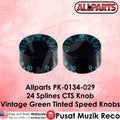 Two vintage green tinted speed knobs with Allparts branding on a pink background.