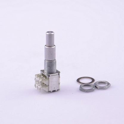 A silver metal rotary switch with a threaded shaft and three pins, shown alongside two metal washers on a plain light background.