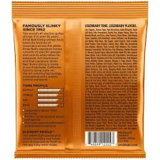 The back of a glossy orange package, showing dense black text, a small ingredient list, and a barcode on a plain white background.