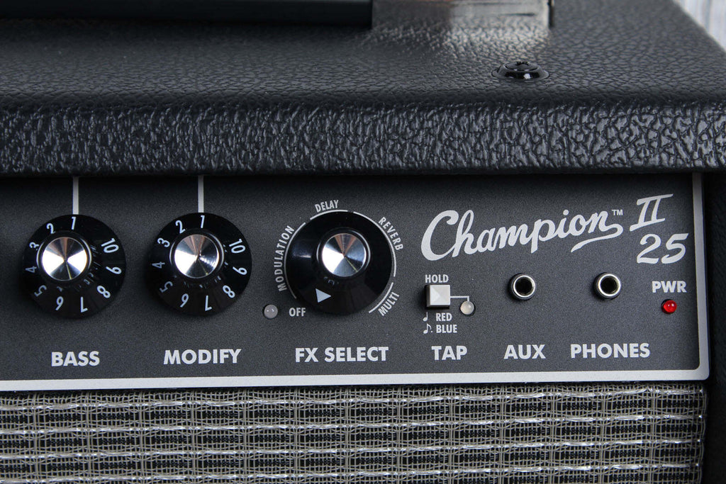 Close-up of a Champion II 25 guitar amplifier panel with control knobs and labels.