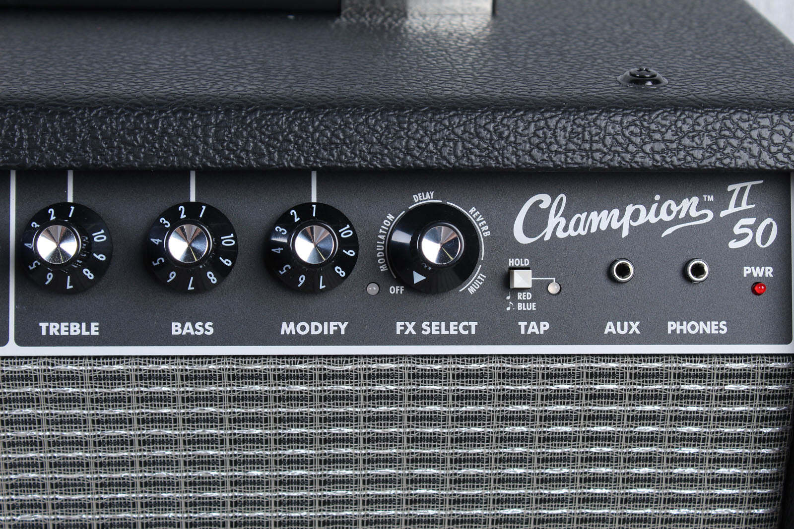 Close-up of a Champion II 50 guitar amplifier with control knobs and labels.
