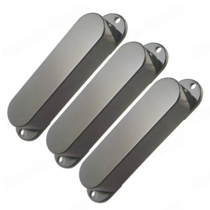 Three dark gray glossy oval-shaped guitar pickups or control covers arranged diagonally on a plain white background.
