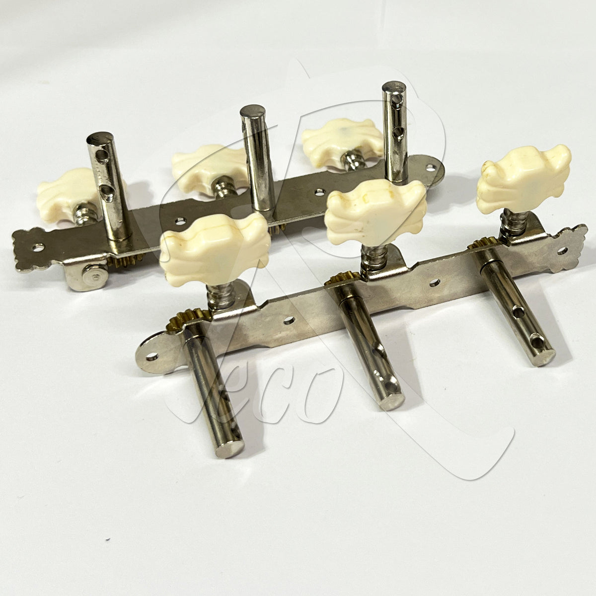 Four guitar tailpiece tuners with cream-colored bone-shaped knobs and silver metal hardware, arranged on a plain white background.