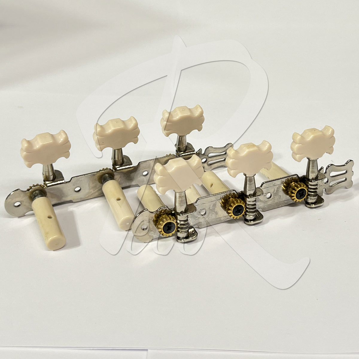 Six guitar tailpiece tuners with cream-colored knobs and metal hardware, arranged on a plain white background.