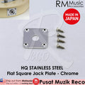 A collection of stainless steel guitar jack plates in different shapes, including flat square and curved oval, designed for electric guitars or basses.