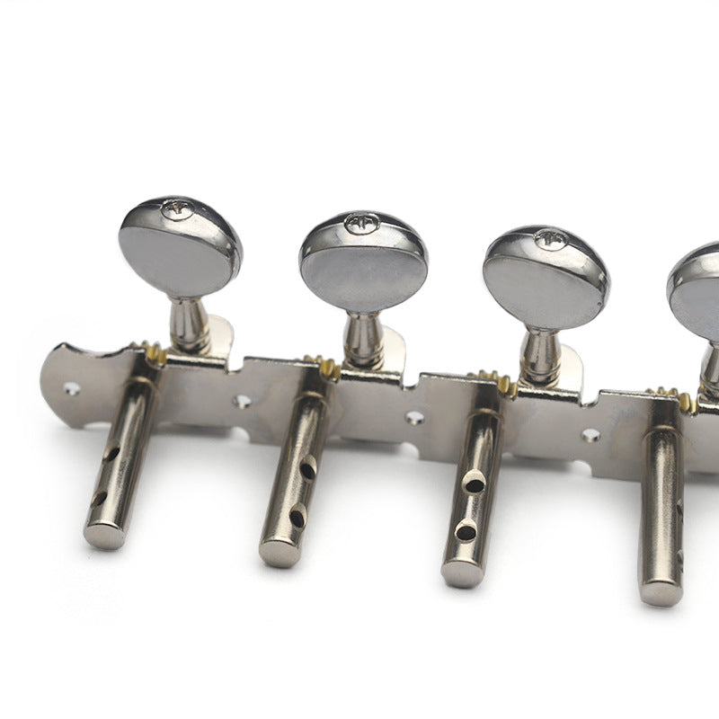 A close-up of a metallic guitar tailpiece with four silver tuning pegs and knobs on a plain white background.