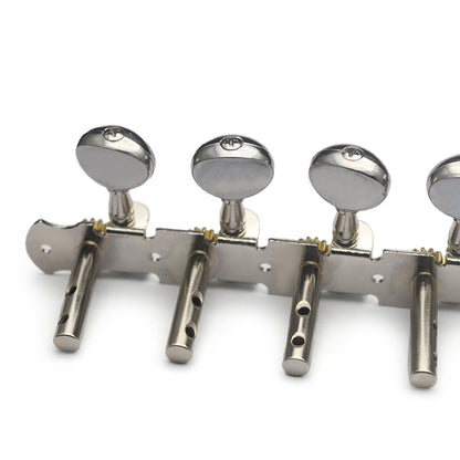 A close-up of a metallic guitar tailpiece with four silver tuning pegs and knobs on a plain white background.