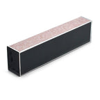 A rectangular metal nail file with a black body, silver edges, and a pinkish-beige abrasive top surface, shown on a plain white background.