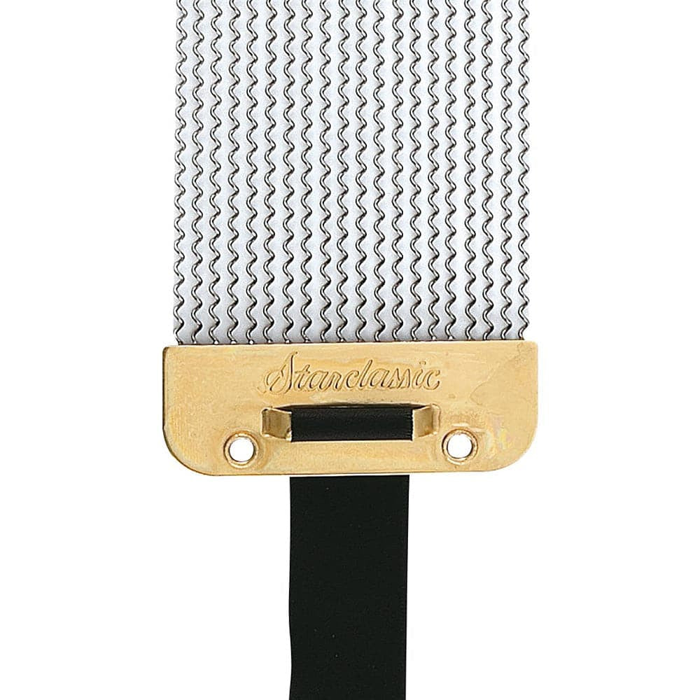 Close-up of a Stanelastic guitar string bridge with a gold-plated metal plate engraved with the brand name, a black saddle bar, and silver metal string trees on a white background.